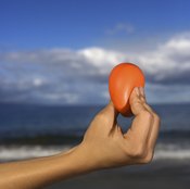 Squeezing a stress ball is a simple and portable way to build hand strength.