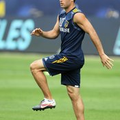The L.A. Galaxy's Landon Donovan dynamically stretches his hip flexors before a training session.