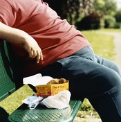 An overweight man sits on a bench.