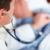 Doctor listening to patient's heartbeat