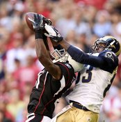 Arizona's Patrick Peterson cuts in front of St. Louis receiver Austin Pettis to intercept a pass.