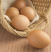 Brown eggs splilling out of a basket.