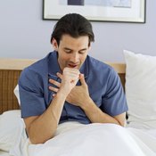 Man coughing in bed