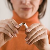 Woman breaking cigarette