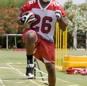 Chris Wells of the Arizona Cardinals works with a high-step agility ladder.