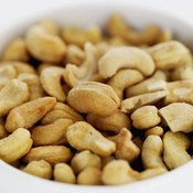 Cashews contain more iron and copper, but less fiber, than almonds.