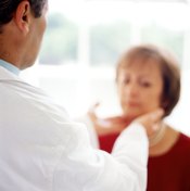 Woman having her throat glands examined