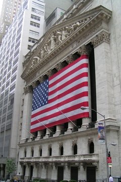 wall street with flag image by Tomasz Cebo from Fotolia.com Bonds and stock both trade in the investment marketplace, but according to different value propositions.