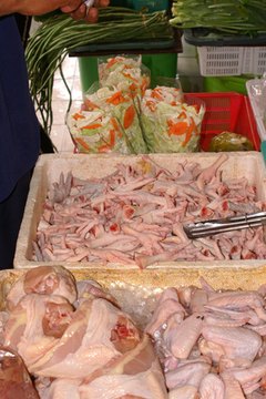 chicken feet image by TiG from Fotolia.com Both raw chicken parts and raw chicken feet can be used in your dog's raw diet.