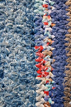 village carpet image by Pomidors from Fotolia.com Clean both sides of an area carpet.