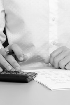 A businessman calculating expenses at tax time image by Christopher Meder from Fotolia.com Software programs that calculate your taxes can help you receive all your tax deductions.