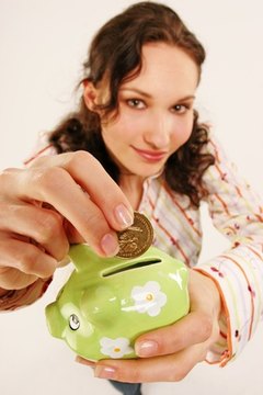 woman with piggy bank image by forca from Fotolia.com Put your money to work for you.
