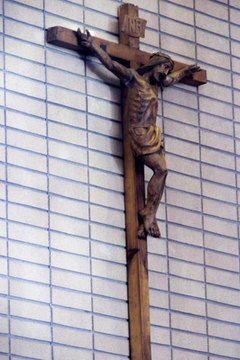 Wearing a crucifix is sometimes an indication one has been baptized.