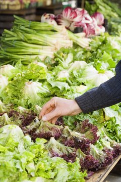 Jupiterimages/Creatas/Getty Images Buying locally grown crops keeps money within the region and may boost the local economy.