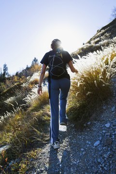 Jupiterimages/Comstock/Getty Images Hill-walking cardio tones the lower body and burns calories.