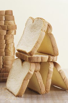 Digital Vision./Digital Vision/Getty Images Foods mostly composed of simple sugars, such as white bread, can slow the metabolism.