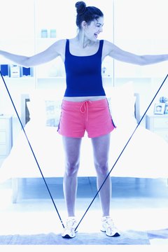 Stockbyte/Stockbyte/Getty Images Use a resistance band to warm up your shoulders before playing tennis.