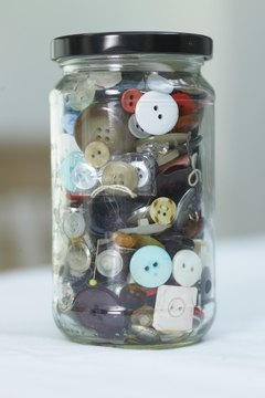 Manipulatives, such as a jar of buttons, can help engage students in descriptive writing.