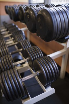 Jupiterimages/Comstock/Getty Images Buy a set of adjustable-weight dumbbells, or try out various weights at a gym.