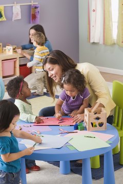 Jupiterimages/Comstock/Getty Images Daycare assistants foster a healthy learning environment for children.