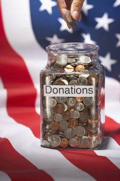Brand X Pictures/Brand X Pictures/Getty Images A development director's skills in fundraising can provide the resources to help a community in need.
