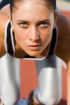 Jupiterimages/Pixland/Getty Images Pay attention to how your feet strike the track during sprints.