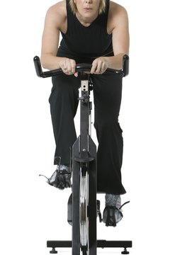 Photodisc/Photodisc/Getty Images A spin bike features a weighted front wheel which mimics outdoor riding conditions.
