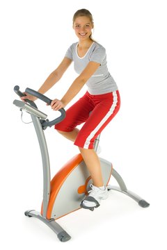 Jupiterimages/Photos.com/Getty Images Get the most out of your stationary bike workout by maintaining the right posture while sitting.