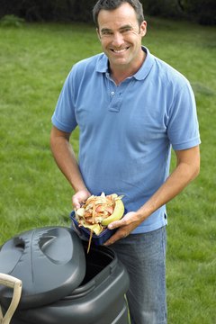 BananaStock/BananaStock/Getty Images Kitchen scraps recycled into rich compost feed a garden by enriching the soil.