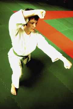 Medioimages/Photodisc/Photodisc/Getty Images Judo encompasses throws, whereas boxing rules only allow punches.