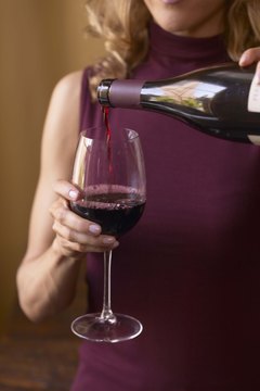 Jupiterimages/Comstock/Getty Images Red wine, in moderation, increases HDL levels.
