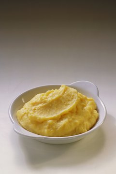 Eising/Photodisc/Getty Images Yukon Gold potatoes give mashed potatoes a rich flavor and a golden color.