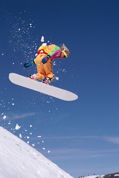 Stockbyte/Stockbyte/Getty Images A tough jump on uneven terrain can cause ugly scratches on your snowboard.