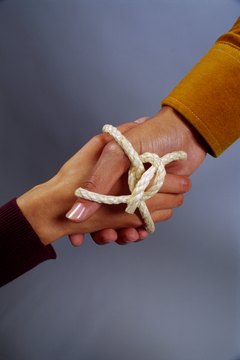 Hand shaking and wrapped in rope