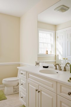 Jupiterimages/Creatas/Getty Images Brighten your bathroom with cosmetic changes to make $3,000 go a long way.