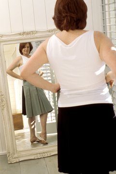 Pixland/Pixland/Getty Images Tone up back flab with strengthening exercises.