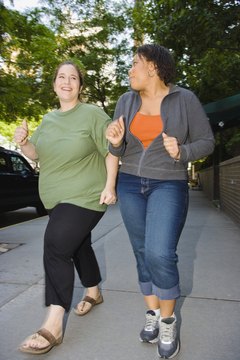 Creatas Images/Creatas/Getty Images Add cardio to your routine to get rid of extra fat.
