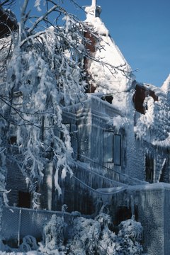 Hemera Technologies/Photos.com/Getty Images A winter wonderland may be beautiful, but heavy snow can collapse a roof.