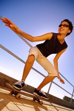 Stockbyte/Stockbyte/Getty Images Skateboarding burns calories at a low rate.