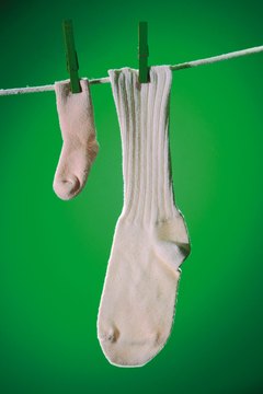 Comstock/Comstock/Getty Images Use baby socks to create dog paw socks.