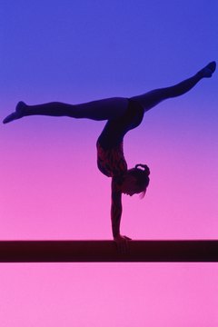 Jupiterimages/Photos.com/Getty Images Female gymnasts should train for increased strength, balance and flexibility.