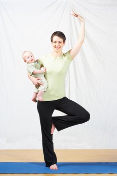 Jupiterimages/Photos.com/Getty Images You can even incorporate your baby into your yoga practice.