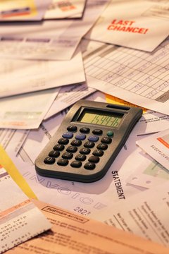 Calculator on pile of invoices