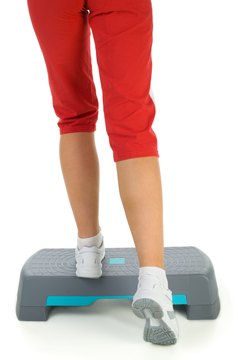 Jupiterimages/Photos.com/Getty Images Burn calories and tone abs with step aerobic and ab workouts.