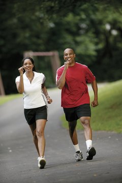 Comstock/Comstock/Getty Images Recruit a walking buddy who pushes you to walk quickly.
