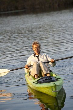 Comstock Images/Comstock/Getty Images Stretch before and after a flatwater kayak session to prevent fatigue and injury.