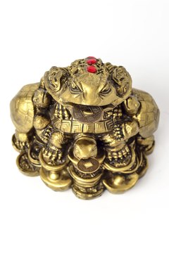 This traditional statue of Ch'an Chu holds a coin within its mouth, perhaps as a way of summoning other coins to follow.
