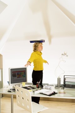 IT Stock/Polka Dot/Getty Images Balancing a book on your head may not be enough to counter years of slouching.