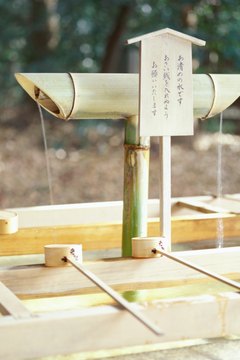 Water is made available at the entrance to Shinto shrines for visitors to wash their hands and mouths.