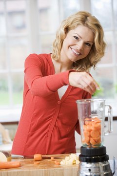 BananaStock/BananaStock/Getty Images Slicing carrots and soaking them will help decrease potassium.